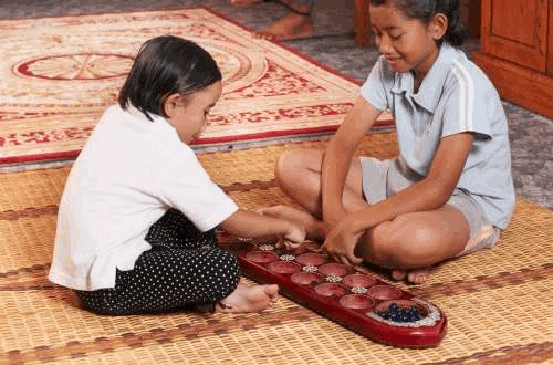 Congkak game being played